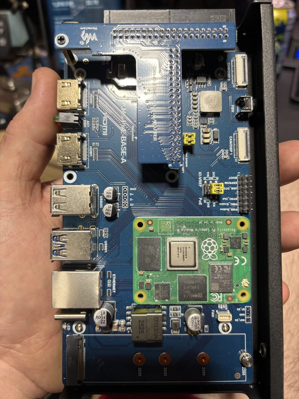 Raspberry Pi compute module carrier board being held during assembly